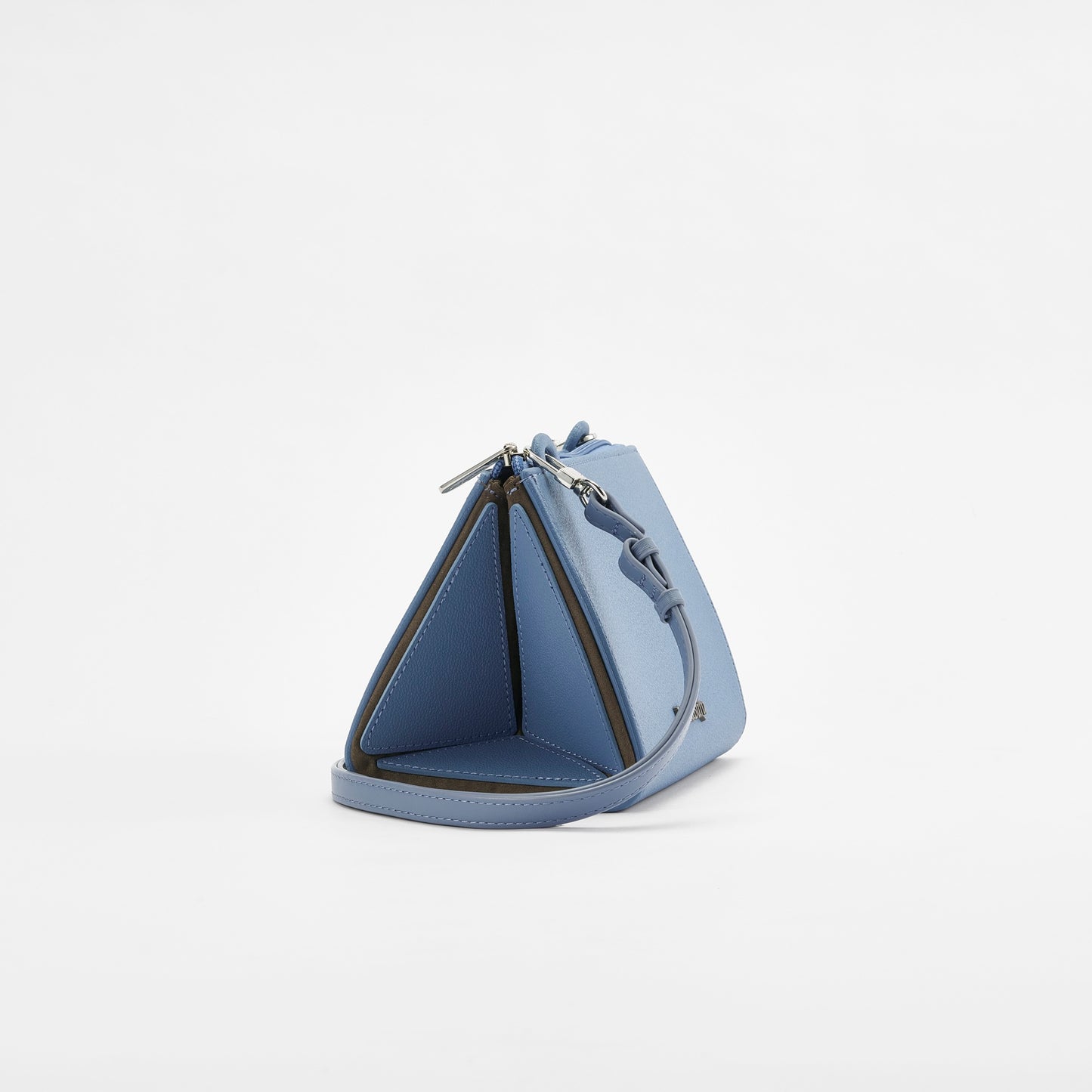 Side view of HuluBulu aqua blue-colored om & out handbag featuring unique multi-compartment structure, silver hardware, and adjustable strap.