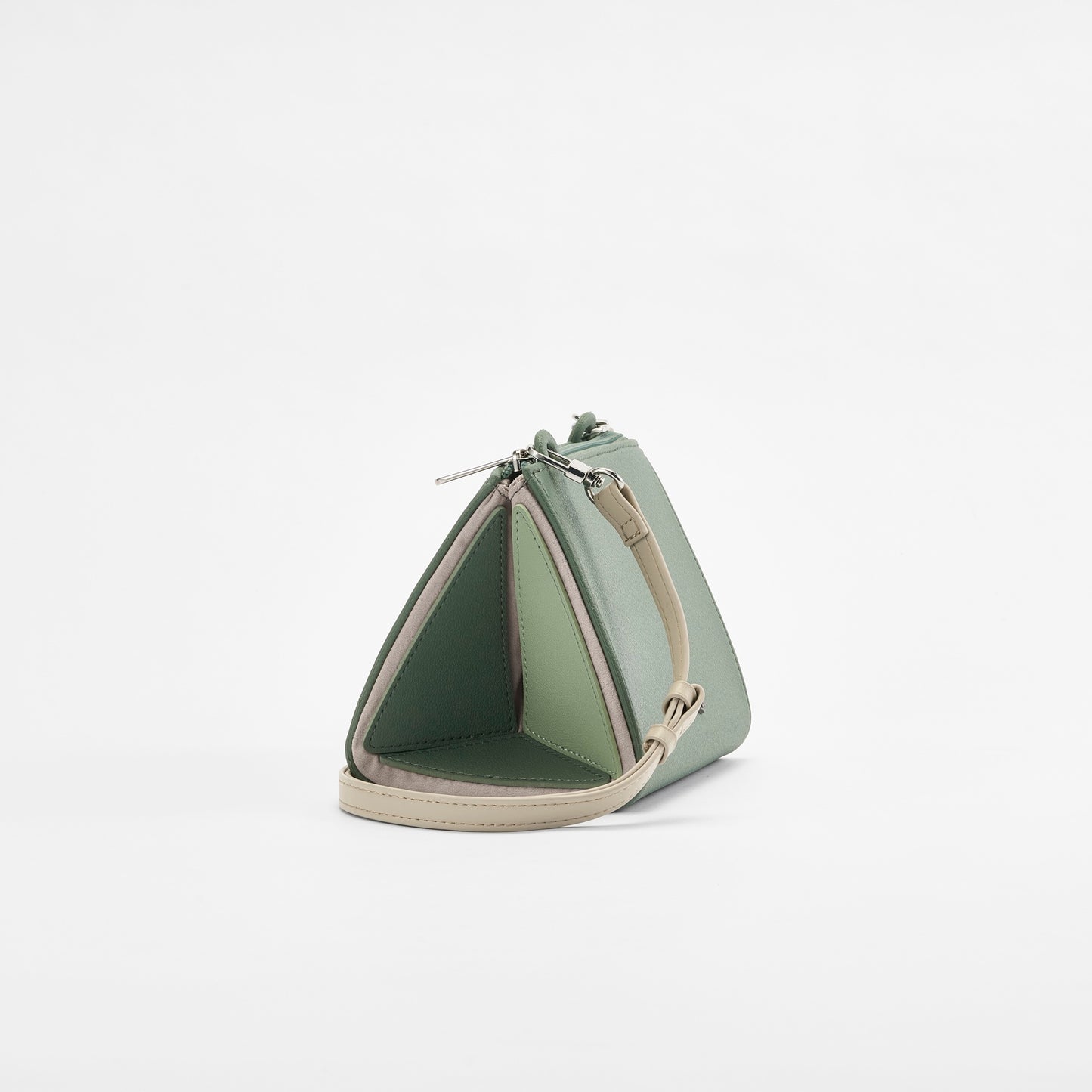 Side view of HuluBulu frey green-colored om & out handbag featuring unique multi-compartment structure, silver hardware, and adjustable strap.